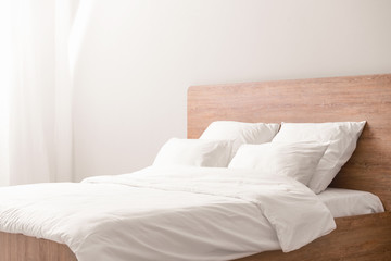 Fototapeta na wymiar Cozy bed with soft pillows