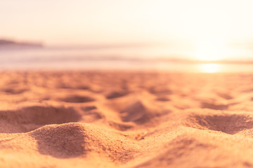 Copy space of soft sand sea and blur tropical beach with sunset sky and cloud abstract background.