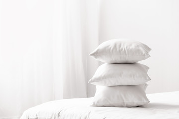Fototapeta na wymiar Soft pillows on cozy bed