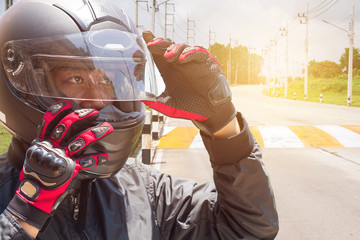 Man in a Motorcycle with helmet and gloves is an important protective clothing for motorcycling...