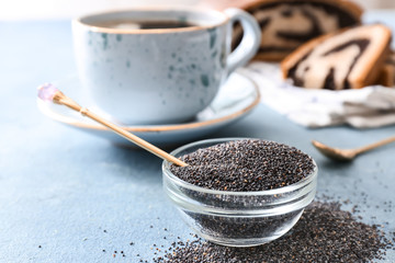 Bowl with poppy seeds on table