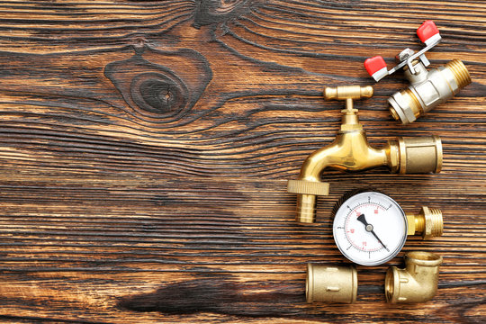 Set of plumbing items on wooden background
