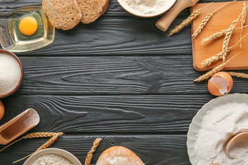 Frame made of flour and products on dark wooden background