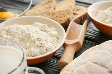 Flour with products on wooden table