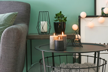 Beautiful burning candles on table in room