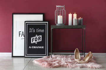 Beautiful burning candles on table in interior of room