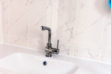 New faucet and white sink in bathroom.