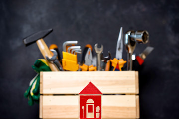 construction tools in wooden box in black background