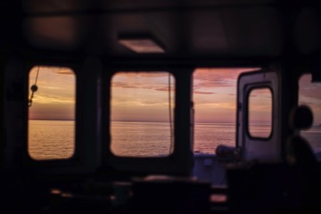 Beautiful sunrise at Baltic Sea. View from bridge of cargo vessel. During morning watch. Background. Blur.