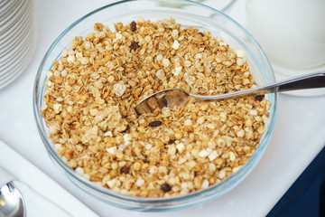 Bowl of nuts, dried fruit and muesli for the preparation of a nutritious vegetarian breakfast. 