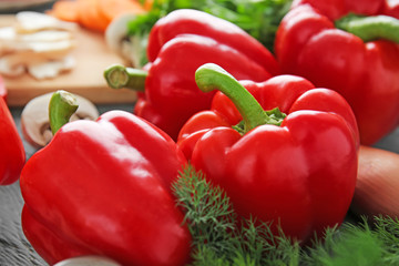 Ripe red peppers on table