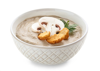 Bowl of tasty mushroom cream soup on white background