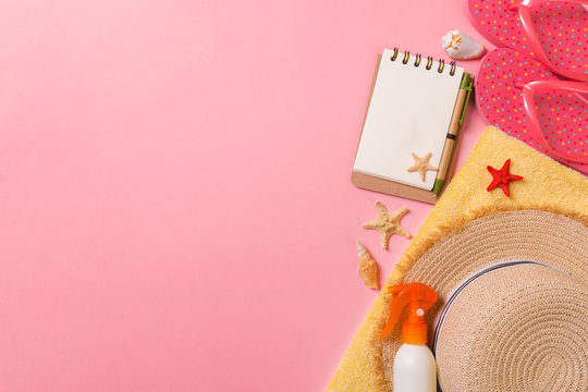 Flat lay, top view Travel concept. summer accessories with note paper and seashell on pink background