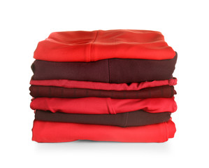 Stack of modern clothes on white background