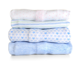Stack of baby clothes on white background