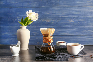 Tasty coffee in chemex on dark table