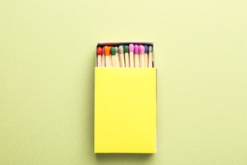 Box with matches on color background