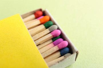 Box with matches on color background, closeup