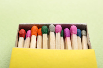 Box with matches on color background, closeup