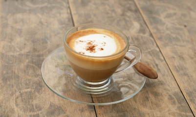 hot cappucino coffee on wood table