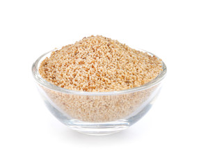 Bowl with poppy seeds on white background