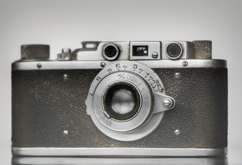 Photograph of a retro iron film camera with a lens close up