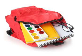School backpack with stationery on white background