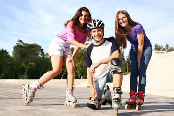 Teenagers on roller skates outdoors