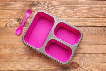 Plastic lunch box on wooden background