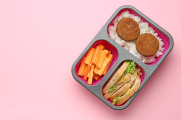 Lunch box with tasty food on color background