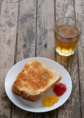 roasted bread with fruit jam and iced juice