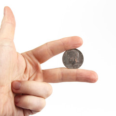 fingers of the hand holding the coin. Finance and Economics.
