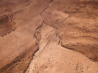 Aerial view of a desert landscape on the island of Lanzarote, Canary Islands, Spain. Desert background, texture. Sand and desolate land