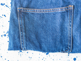 Pair of denim jeans on white and blue background. Texture. Flat lay
