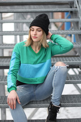 The girl is blonde in a green blue croptop. Street style. Advertising brand clothing. Fashion Shooting
