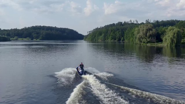 Jet ski riding on water surface of the lake - water scooter