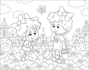 Cute little girls playing with a small toy rabbit among flowers on grass of a lawn against a background of houses of a small town, black and white vector illustration in a cartoon style