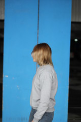 Girl  blonde  in grey hoodie. Street style. Advertising brand clothing. Fashion Shooting. Mockup.