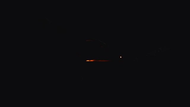 A blacksmith with a welding mask and welders leathers, is welding metal products in the garage, fire sparks fly to the sides. Dark mood. Slow Motion shot with Red Monstro 8K.