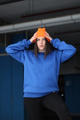 Girl  in blue hoodie. Street style. Advertising brand clothing. Fashion Shooting. Mockup.