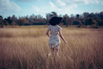 young woman in a wide open field with pleasure Vintage style tone