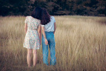 Hand on heart-shaped bokeh background blurred, natural tones vintage style. Show the world you love Love Family between two people.Let's Stay Together happy mother's day,