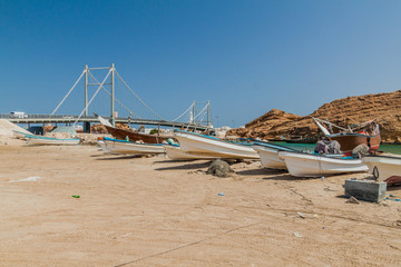 Fototapeta na wymiar Fishing boats in Sur, Oman. Khor al Batar bridge in the background.