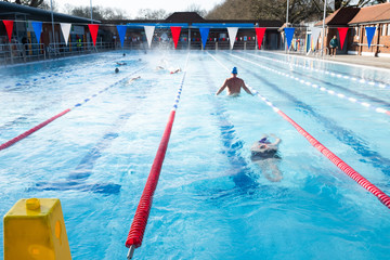 Swimmers compete in the London Fields aquathlon - obrazy, fototapety, plakaty