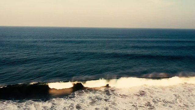 Aerial footage filmed with a drone overlooking the beach and sea of crashing waves with a deep blue ocean on the Bluff in Africa southern hemisphere.