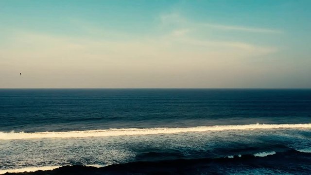 Aerial footage filmed with a drone overlooking the beach and sea of crashing waves with a deep blue ocean on the Bluff in Africa southern hemisphere.