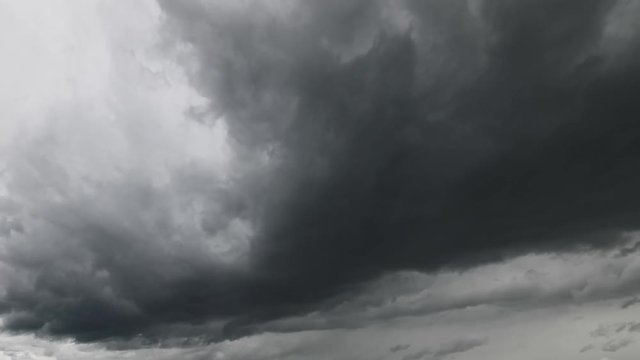 Time lapse of churning white, grey and black storm clouds