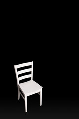 Modern white chair on black background.