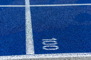 Fototapeta na wymiar blue tartan running track with number 100 painted on it