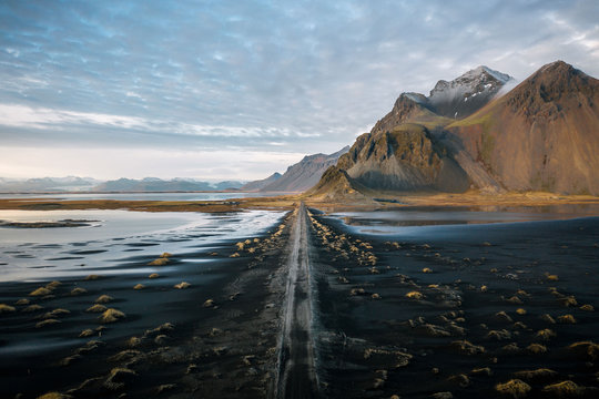View of road passing through Stokksnes Beach during sunset